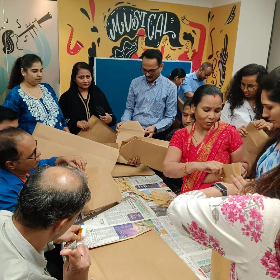 MSS trainees running a DIY bag-making workshop at a corporate office
