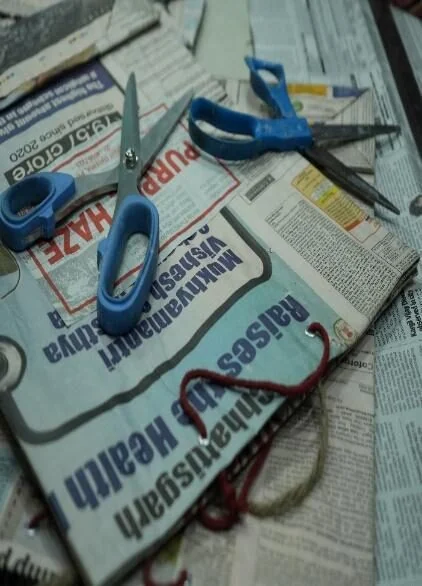 Early MSS training: cutting newspaper to make paper bags