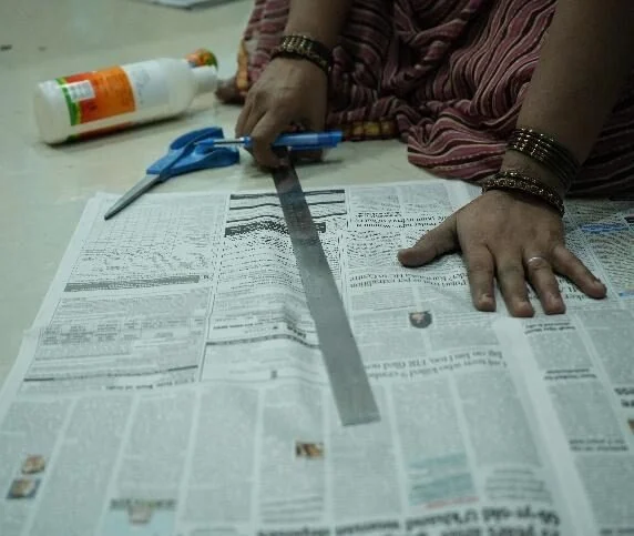 Then: measuring and cutting newspaper