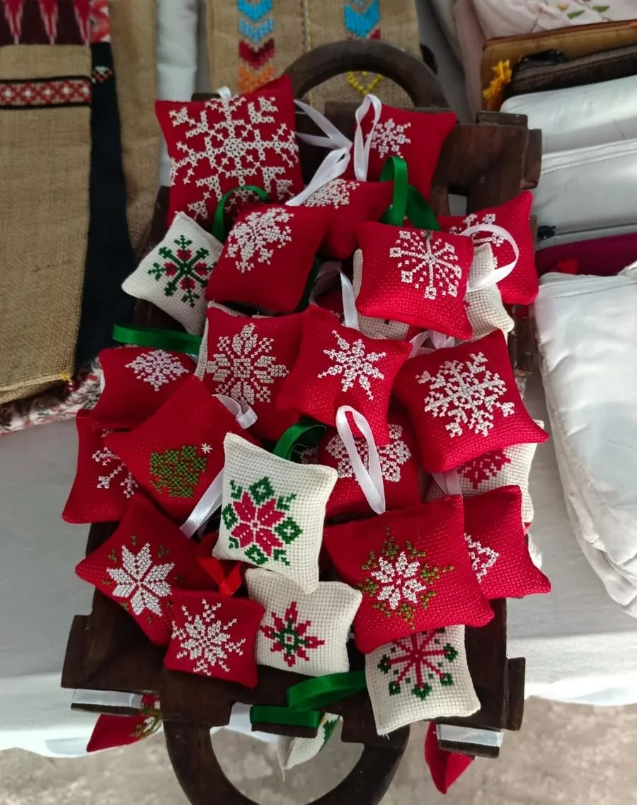 Cross-stitch Christmas ornaments in red and cream