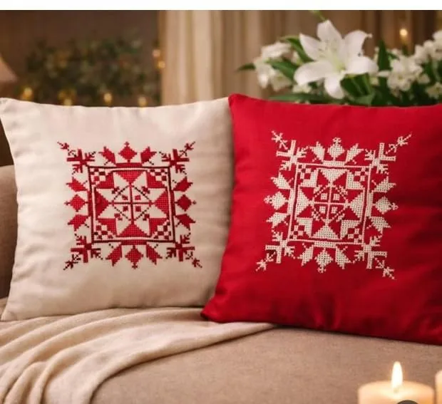 Red and cream cushion covers with cross-stitch medallions