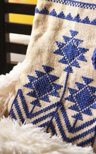 Sling bag with a blue cross-stitch motif