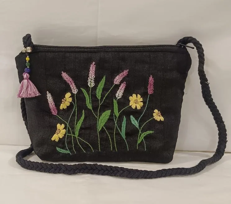 Black sling bag hand embroidered with wildflowers