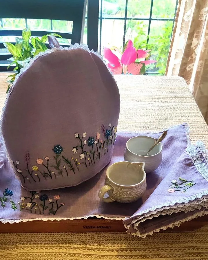 Lilac tea cosy embroidered with wildflowers