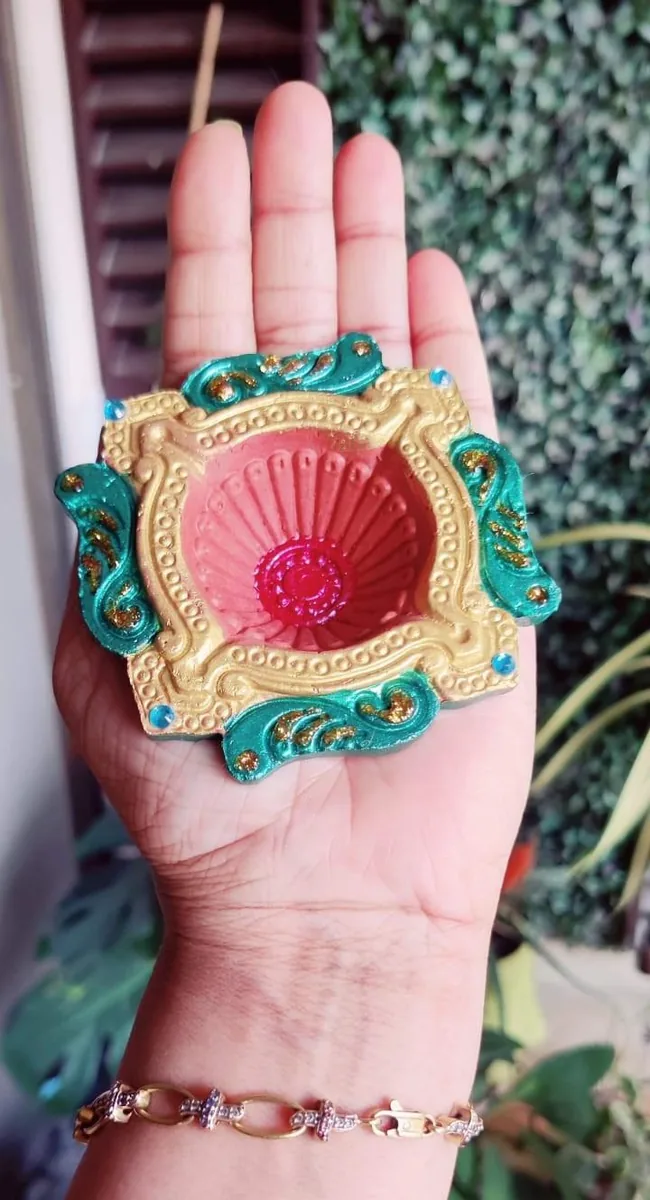 Hand-painted clay diya in teal and gold